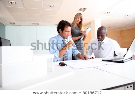 Foto stock: 3 People Looking At Architectural Model