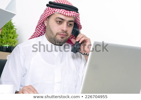 Foto stock: Bearded Arabic Businessman Talking On Phone