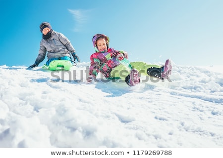 [[stock_photo]]: Kids Sliding On Sleds Down Snow Hill In Winter