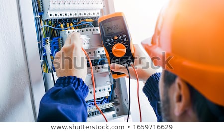 Stock photo: Man Mounting Electric Fuse