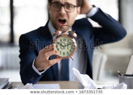 Сток-фото: Anxious Businessman Holding A Clock