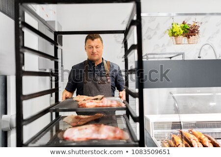 Foto d'archivio: Seller With Smoking Tray At Fish Shop