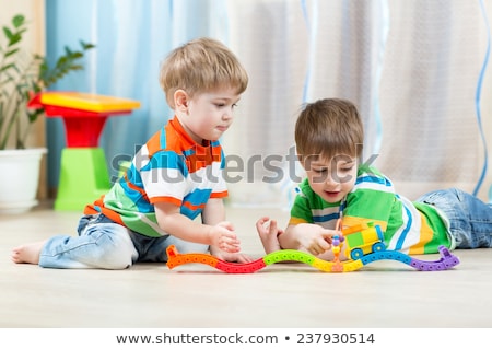 Stockfoto: A Boy Is Playing With A Toy Railroad