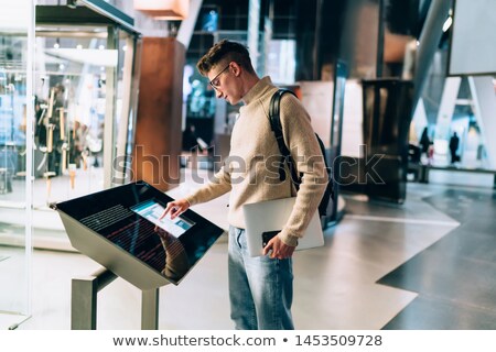 Stock foto: Hand Navigating Online Shop On Interactive Panel