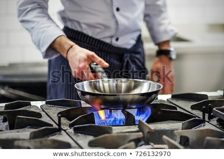 Hand And Frying Pan With Gas Stove Foto stock © Koldunov