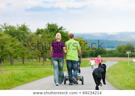 Young Couple Walking Down Hill With Dog Foto d'archivio © Kzenon