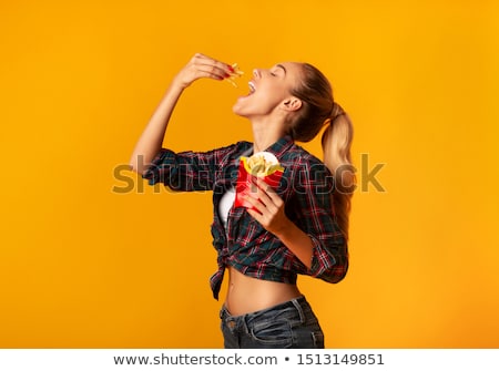 Stockfoto: Young Woman Eating Chips
