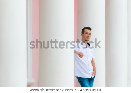 Stock photo: Casual Business Man Leaning On A White Column