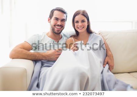 Foto d'archivio: Cute Cheerful Young Woman In Pajamas Drinking Tea