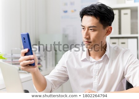 [[stock_photo]]: Asian Businesspeople Using A Cellular Telephone