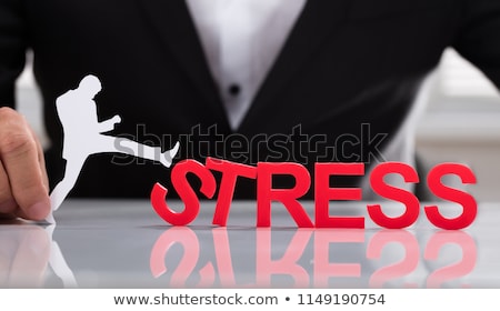 Foto stock: Businessperson Kicking Stress Word