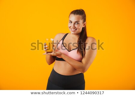 Foto stock: Image Of Sporty Chubby Woman In Tracksuit Smiling And Holding Gl