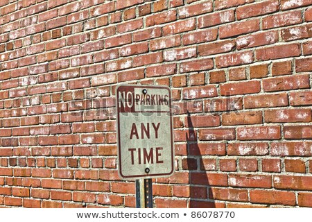 [[stock_photo]]: No Parking Sign In Front Of Brick Wall