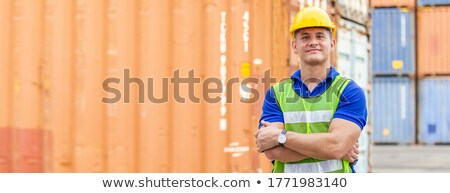 Stockfoto: Happy Worker Standing At Warehouse