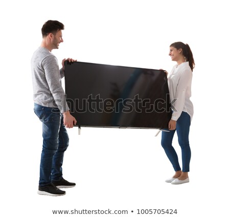 Foto d'archivio: Happy Young Couple Carrying Television