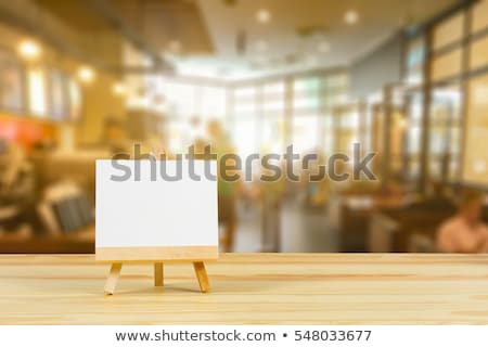 Stok fotoğraf: Wooden Easel With A Blank White Canvas In Modern Cafe