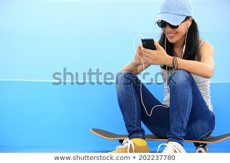 Stock fotó: A Girl Listening To Music At The Park