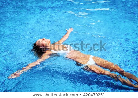 Foto stock: Restful Girl In Swimsuit Spending Day In Swimming Pool