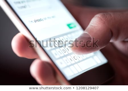 ストックフォト: Person Sending Text Message From Smartphone