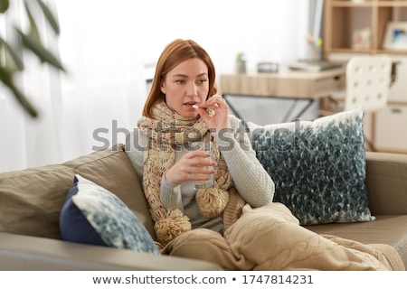 Foto stock: Sick Woman Taking Medicine With Water At Home
