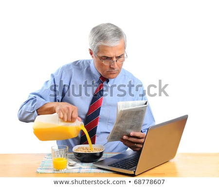 Zdjęcia stock: Man Eating Breakfast In Front Of His Laptop