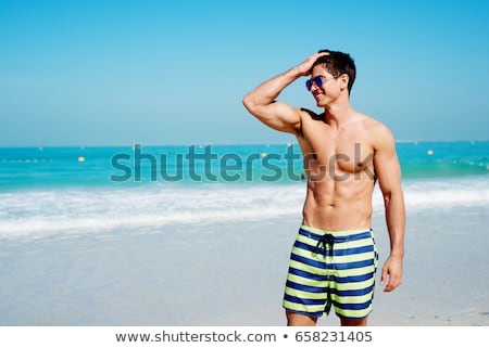 Foto stock: Young Fitness Model Man On The Beach