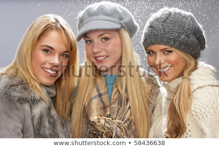 Stok fotoğraf: Two Fashionable Teenage Girls Wearing Cap And Knitwear In Studio