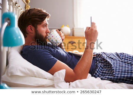 Foto stock: Drinking Coffee And Texting With Mobile Phone In Morning