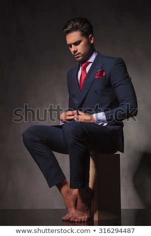 Stok fotoğraf: Barefoot Young Business Man Closing His Jacket