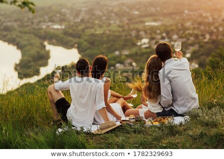 Foto stock: Happy Friends Interacting While Having Glass Of Wine