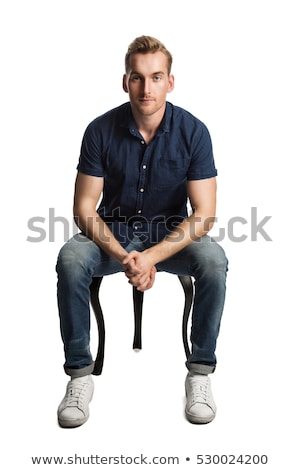 Stock fotó: Man Sits With Hands Clasped