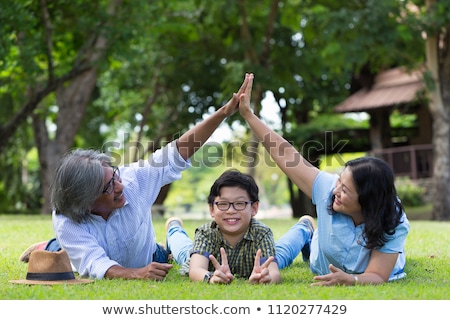 Stok fotoğraf: Happy Senior Couple Holding Hands Over House