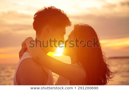 Stockfoto: Young Couple Kissing On A Romantic Tropical Beach