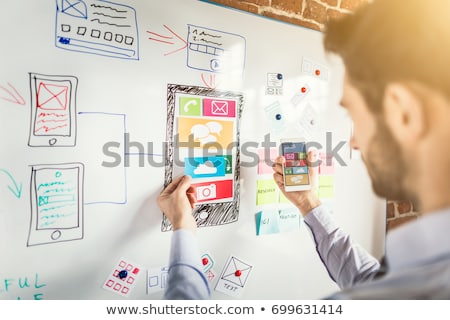 Foto stock: Ui Designer Or Developer Hand Holding Smartphone