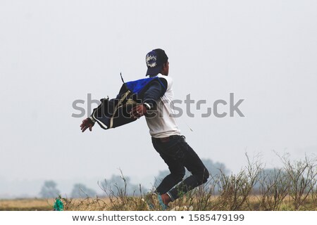 Сток-фото: Full Length Of Casual Man Balancing On Toes