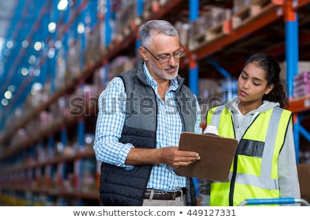Foto d'archivio: Businessman Showing Warehouse To Worker