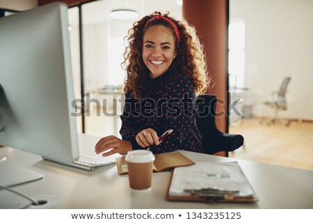 Stockfoto: Smiling Young Businesswoman Working In Her Office