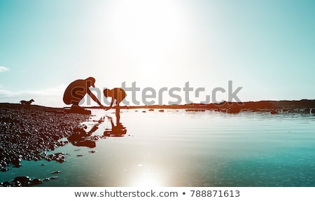 Parents With Child In Sea On Sunset Foto stock © DisobeyArt