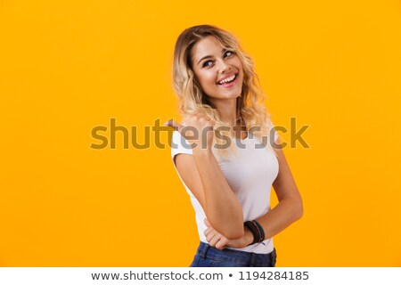Stockfoto: Photo Of Kind Blond Woman In Basic Clothing Smiling And Pointing
