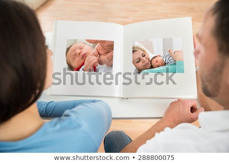 Zdjęcia stock: Couple Looking At Mother And Daughters Photo Album