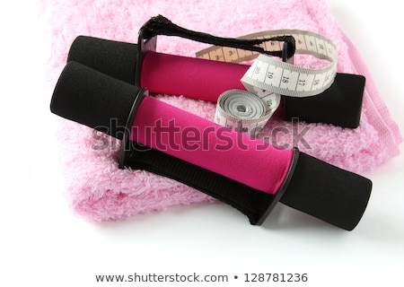 Foto d'archivio: Black Pink Dumbbell With Handle And Measuring Tape On Towel