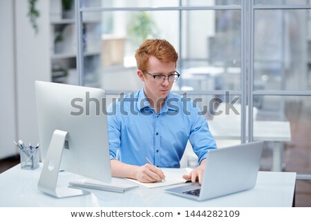 Stock fotó: Young Programmer Looking Through Software On Laptop Display