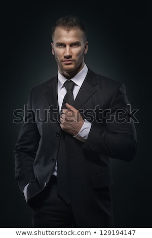 Cool Businessman Standing On Dark Gradient Background Foto d'archivio © doodko