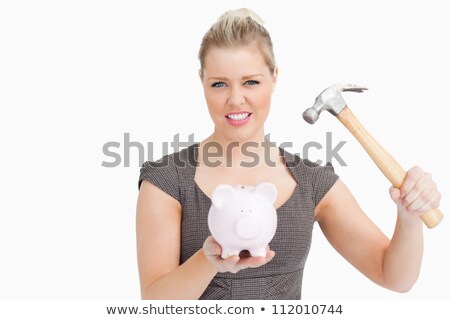 Stok fotoğraf: Woman Wanted To Break A Piggy Bank Against White Background