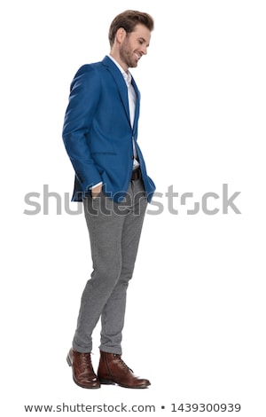 Stock fotó: Young Business Man Looks Down With Hands In Pockets