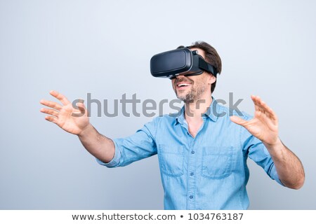 Foto stock: Joyful Cheerful Man Wearing Virtual Reality Device