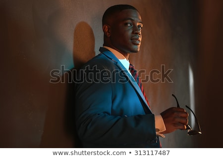 Stock fotó: Portrait Of Handsome Man In Black Clothes Holding Sunglasses