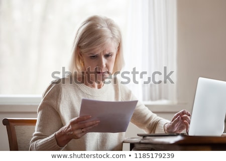 Stok fotoğraf: Elderly Woman Worry About Bill Notice At Home