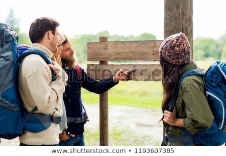 ストックフォト: Hiking Friends With Backpacks At Signpost