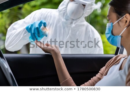 Stock photo: Medical Staff Give Hand Sanitiser At Drive Thru Hospital